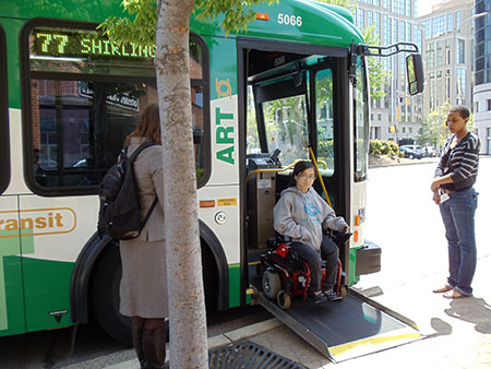 Photo: Person using wheelchair boarding ART bus