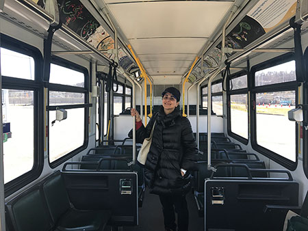 Photo: Negar Ahkami with her paintings on ART bus